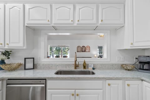 Ample counters and a sleek open window overlooking the yard.