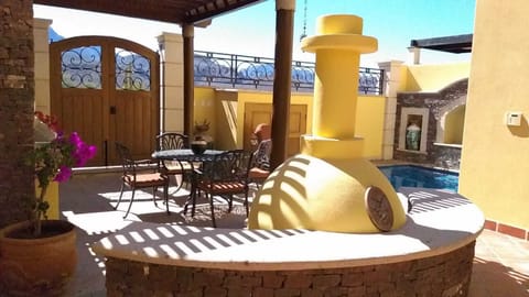 Ground Floor Patio with BBQ center, outdoor fireplace, dining table & pool 