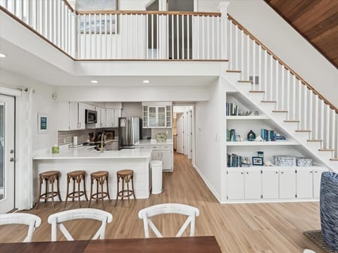 Modern kitchen with white cabinetry, stainless steel appliances, and spacious island for entertaining.