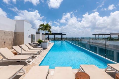 Soak up the sunshine beside the sparkling rooftop pool, complete with loungers and sweeping views.