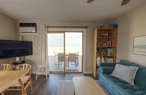Cozy living room with TV and private deck for relaxing outdoor dining