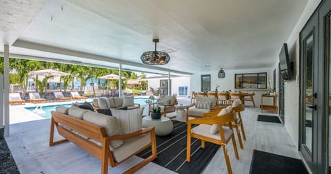 Designed for luxury and comfort, this outdoor space invites you to dine, relax, and unwind in true resort fashion. Enjoy poolside loungers, shaded patio seating, and an ambiance that blends modern elegance with the ease of Florida living