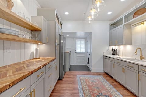 The kitchen provides generous countertop areas with plenty of room to prep meals, bake, or gather with friends or family.