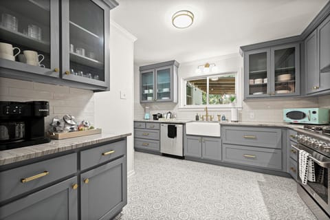 Kitchen Bliss: Stylish gray cabinetry and modern appliances create culinary inspiration!