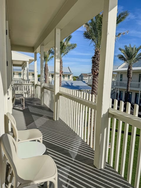 Inviting balcony offering outdoor seating and a relaxing spot to take in the coastal atmosphere.