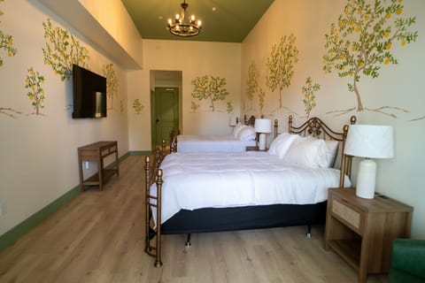 Features 2 King beds, hand-painted mural, and cozy finishes with balcony access
