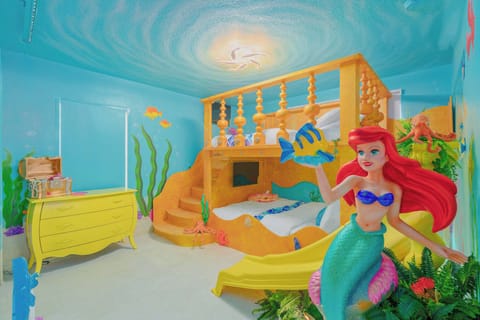 Little Mermaid themed queen bunk bed with slide, Roku smart TV's special effects lighting, luxury linens, games, and ensuite bathroom 
