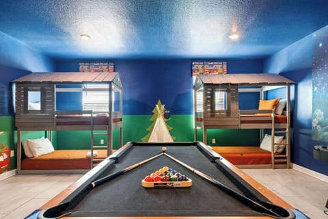 Bunk beds & billiards! Camp-themed room with treehouse beds and a pool table.