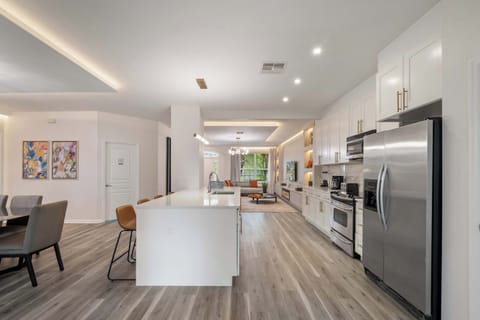 Bright, luxurious kitchen flowing into the living space.