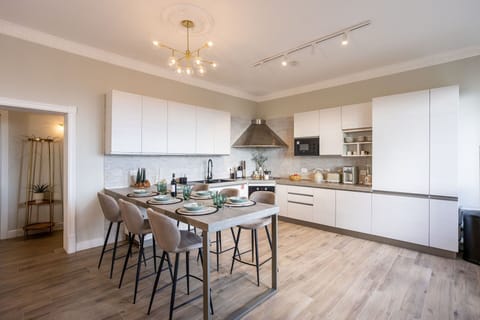 Furniture, Interior Design, Kitchen, Flooring, Countertop, Floor, Chair, Light Fixture, Wood, Kitchen & Dining Room Table