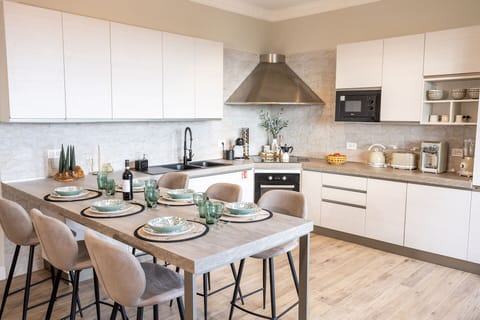 Furniture, Interior Design, Kitchen, Flooring, Countertop, Wood, Chair, Cabinetry, Kitchen Appliance, Tableware