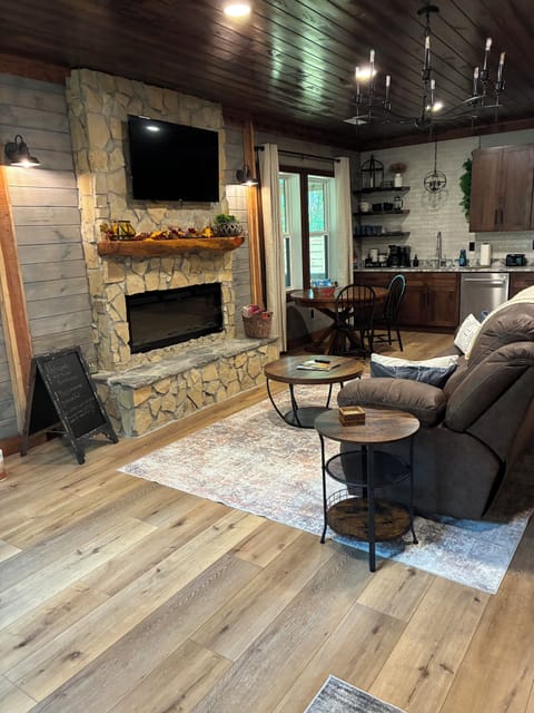 Living space with roku tv, electric fireplace, and recliner sofa