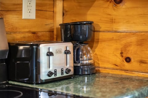 A cozy coffee corner with a toaster and drip maker makes mornings simple and stress-free.