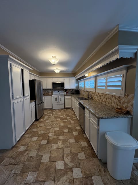Large kitchen with stainless steel appliances. 