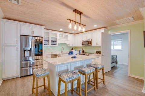 A stylish kitchen island with stools, perfect for casual meals and gathering.”