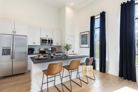 Modern kitchen with barstool seating (Unit 101, 201, 202, 301, 302, 401, 402)