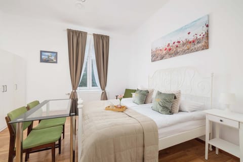 A bright bedroom with a double bed and soft textiles, offering a restful atmosphere.