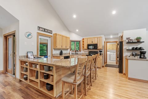 Your spacious kitchen features granite counters, warm wood cabinets, and a breakfast bar perfect for morning coffee together.