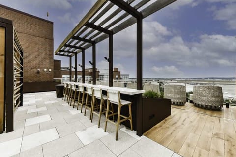 Social rooftop with scenic city view.
