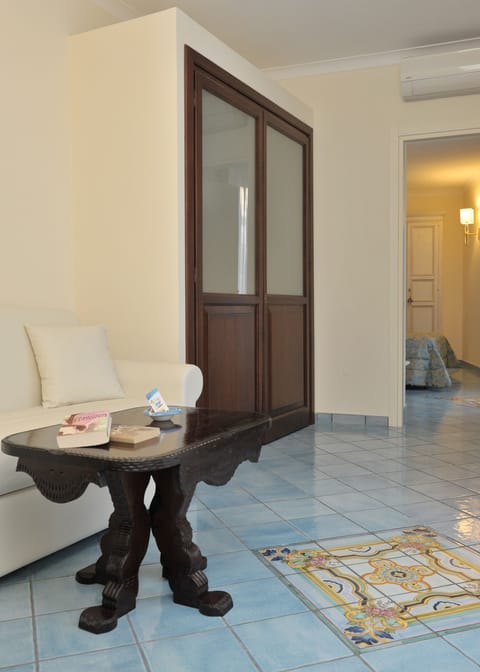 Junior Suite | Living room | 23-inch LCD TV with satellite channels, TV