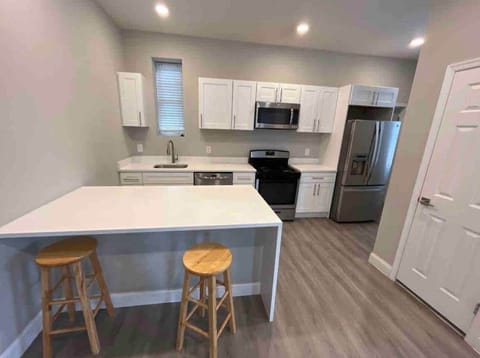 Big kitchen with breakfast bar.
Dishwasher , oven range , microwave, 33 inch refrigerator. 
Connected to a big living room and powder room on the same floor.