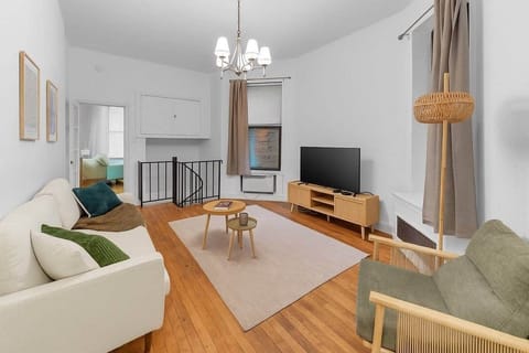 Cozy living room with TV, modern décor, and seating for relaxation & gatherings