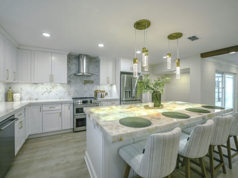 Large quartzite countertop island provides xtra eating space & room to gather!