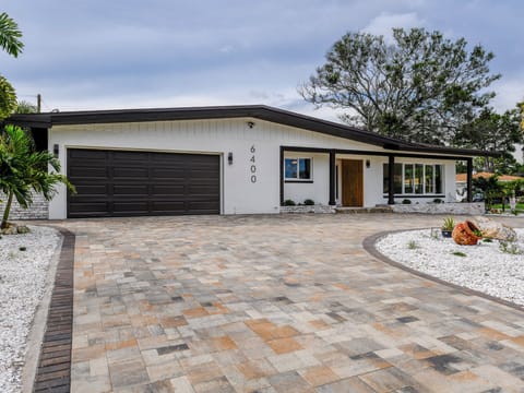 2 car garage with gigantic paver driveway.  Enough room for at least 5 vehicles 