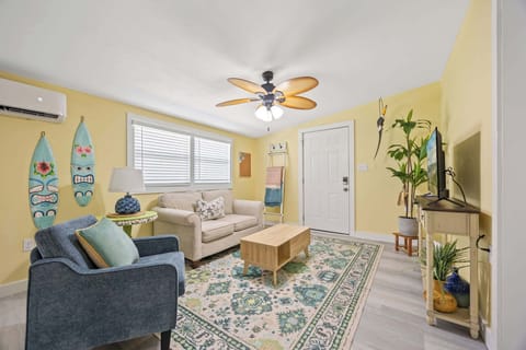 Cozy living room with tropical decor and a ceiling fan for comfort.