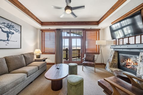Stone Fireplace, Leather Chairs & French Door Views
