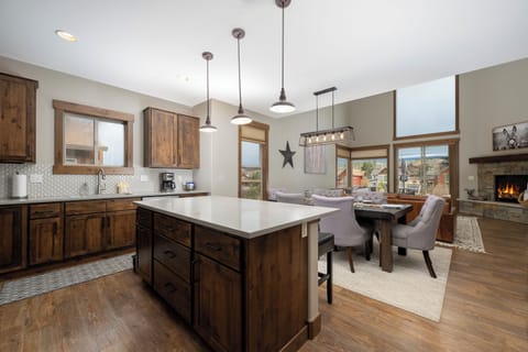 Your open-concept kitchen flows seamlessly into warm dining and living spaces, perfect for gathering with loved ones.
