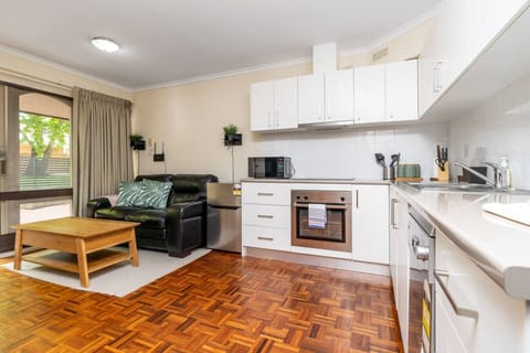 Spotless countertops, sleek appliances, and ample space for cooking and dining in style.