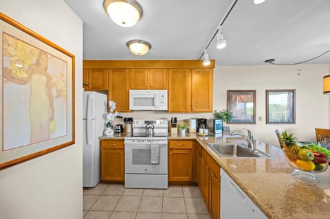 Fully equipped kitchen with a refrigerator, dishwasher, and stove/oven, plus all the essentials for enjoying home-cooked meals.
