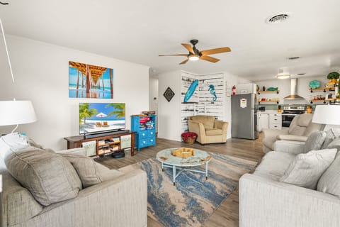 Bright, open-concept living area with plush seating and a Smart TV—perfect for family nights in.