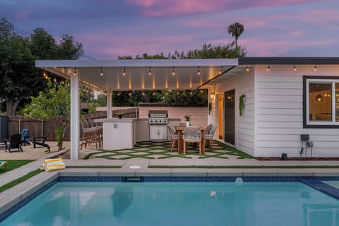 Enjoy resort-style living with your own outdoor kitchen and poolside dining.
