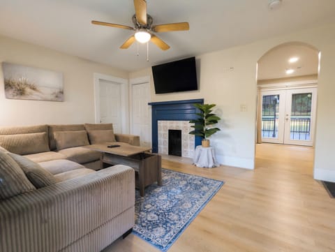 Comfortable, spacious sectional, decorative fireplace, large TV, lift-top table