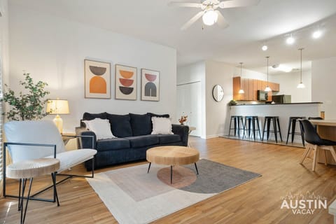 Lounge vibes: bold art, soft lighting, and a couch that’s basically calling your name.