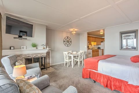 The King Bed Studio features a plush king bed and an inviting seating area, perfect for relaxation near the cozy fireplace.