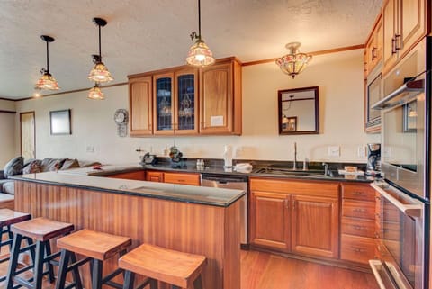 The gourmet kitchen boasts polished wooden cabinetry and ample countertop space, perfectly designed for family gatherings and culinary delights.
