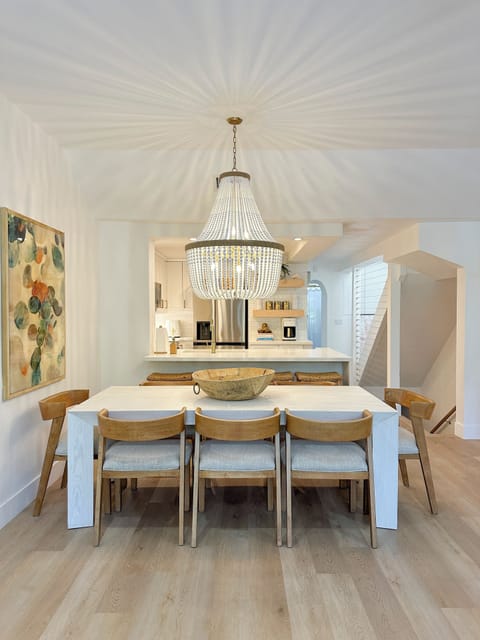 Dining area with seating for eight and a coastal chandelier.