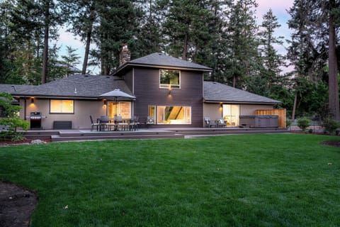 Enjoy the spacious backyard and deck during your family BBQ.