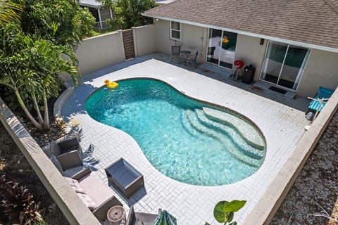 Look down on your vacation! Our stunning pool area, nestled within lush greenery, offers the perfect escape. See yourself lounging by the water, soaking up the sun in your own private retreat.