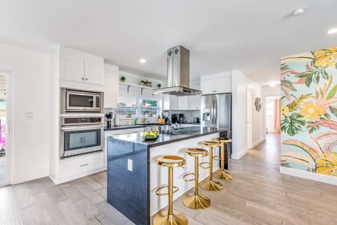 Sleek kitchen with island and barstool seating.