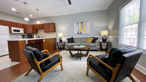 Step into a cozy, art-filled living room with a view.