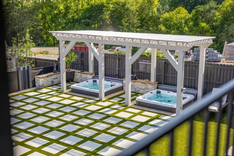 Enjoy the ultimate relaxation with two private hot tubs under a sleek pergola. This well-designed oasis is perfect for unwinding after a day of exploring or hosting under-the-stars hangouts.