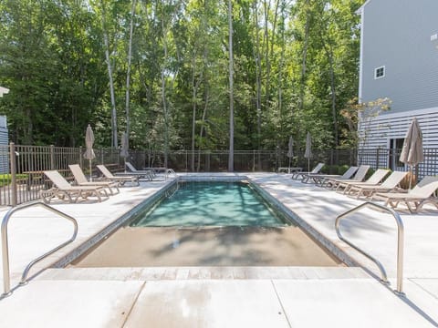 Refresh and unwind in the community pool, surrounded by peaceful wooded views.