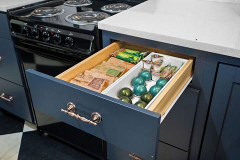 Coffee pods, sugar, creamer, and light breakfast items are provided.