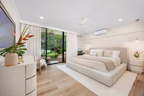 Serene bedroom with a plush king bed, cozy textures, and lanai access for island