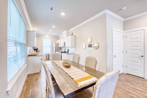 Fully equipped kitchen with stainless appliances, breakfast island, and coffee bar—everything you need to cook and connect.
