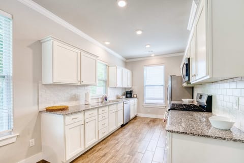 Chef’s kitchen with stainless appliances, granite counters, and a coffee bar stocked for morning brews.
